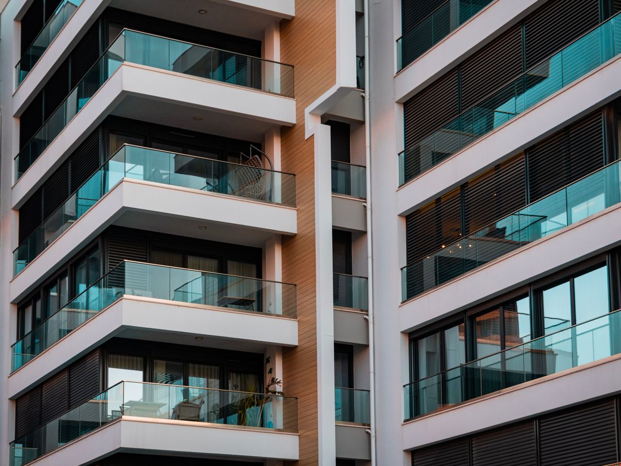 services-03 Contemporary architecture showcasing glass balconies and sleek design.