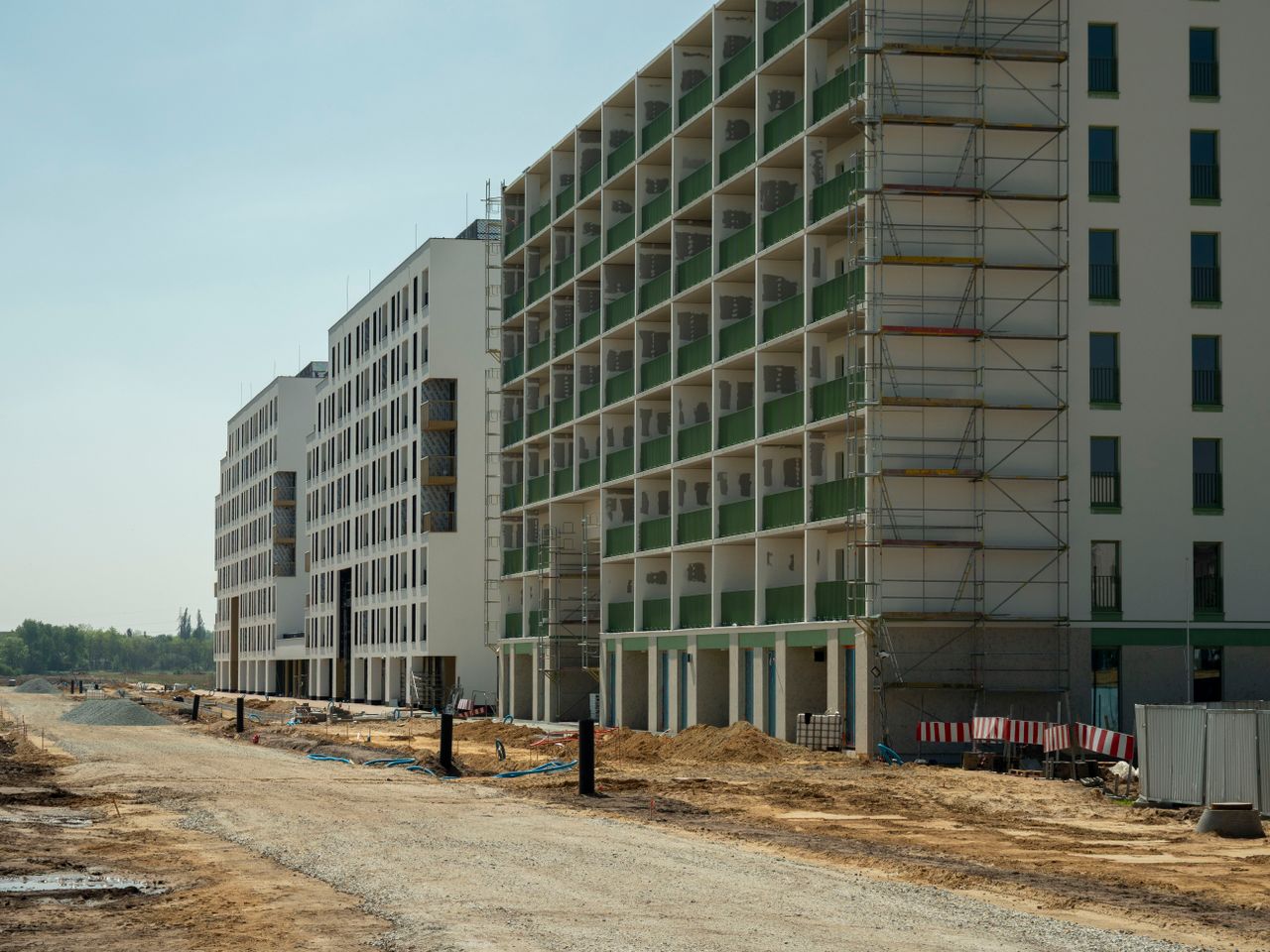Residential buildings in Wrocław, Poland, under construction, showcasing modern architecture.