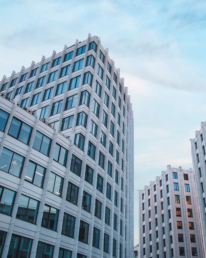 A cityscape featuring contemporary glass buildings in an urban setting at daytime.